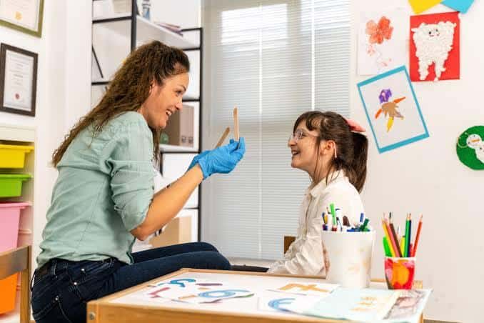 Speech-language pathologist conducting a one-on-one pediatric evaluation.