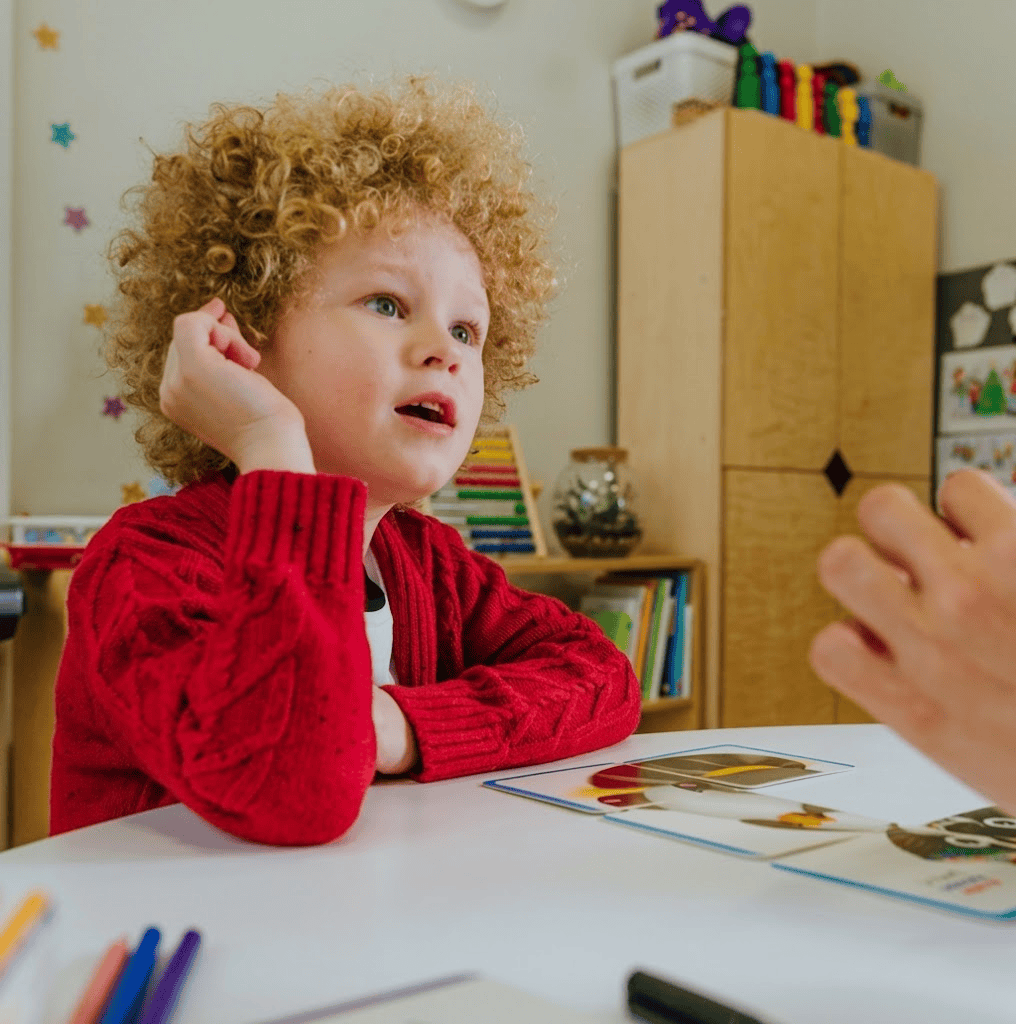 Young child working with picture cards during a speech and language session